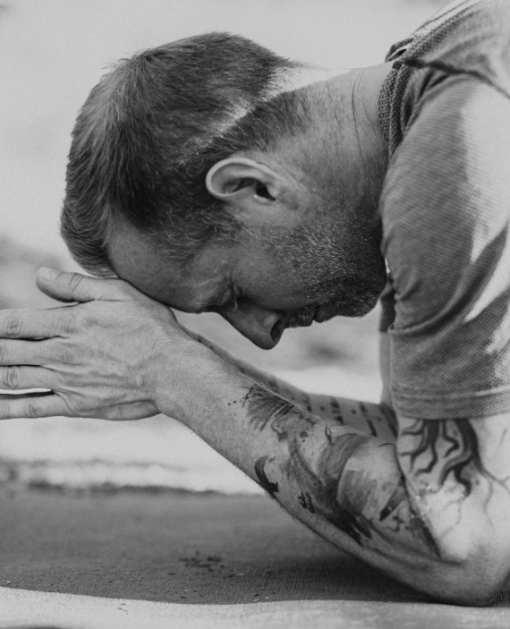 man bowing head in prayer